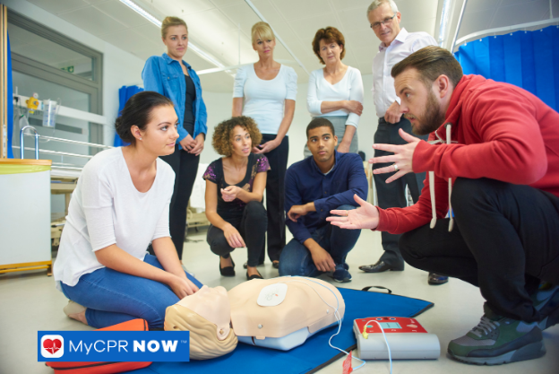 A group of people practicing CPR on training mannequins.