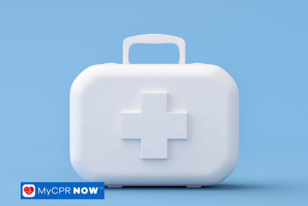 A white first aid kit with a cross symbol on a blue background.