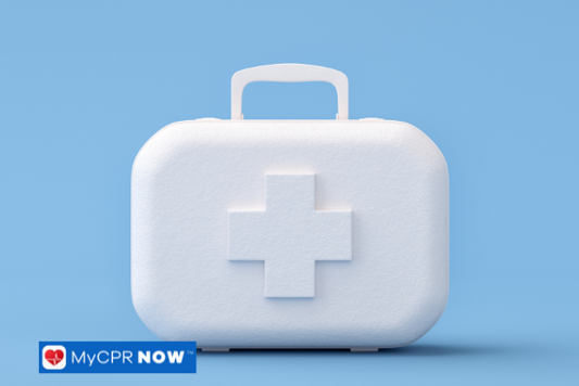 A white first aid kit with a cross symbol on a blue background.
