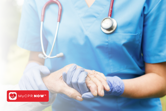 A medical professional in scrubs, with a stethoscope around their neck, and holding someone's hand.  