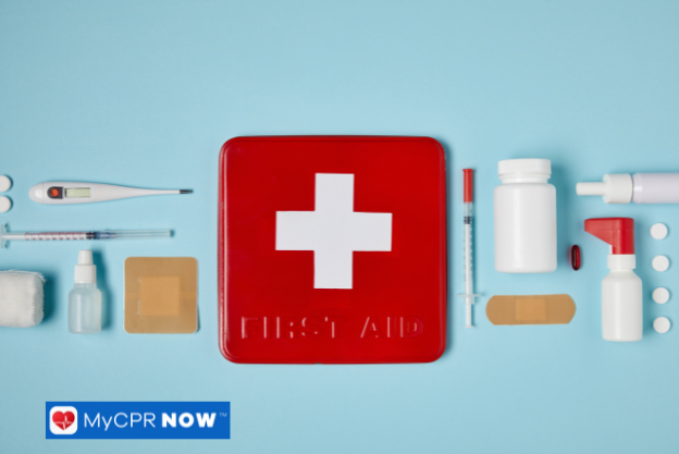 A neatly organized first aid kit with medical supplies, including a red case with a white cross.