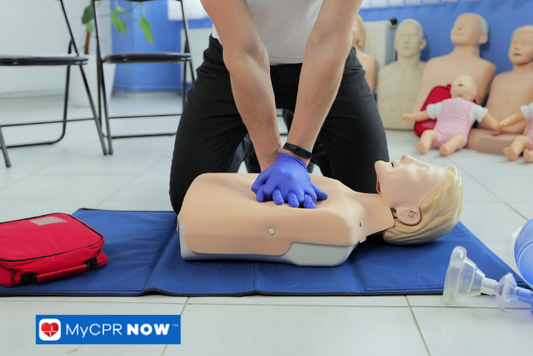 Person performing CPR on a dummy.