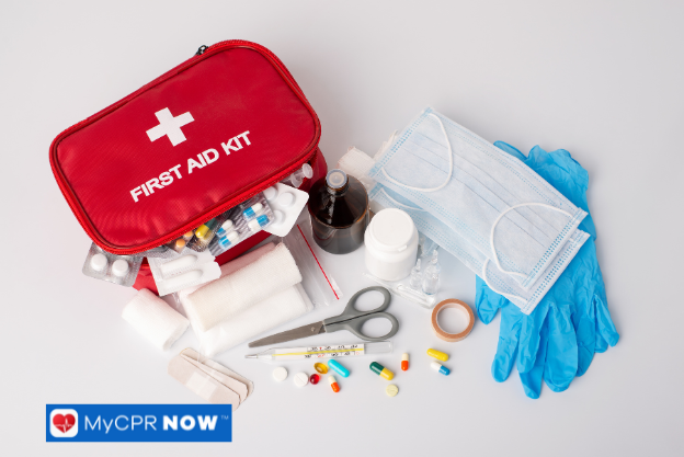 Open first aid kit with various medical supplies, including gloves, scissors, and medicine.
