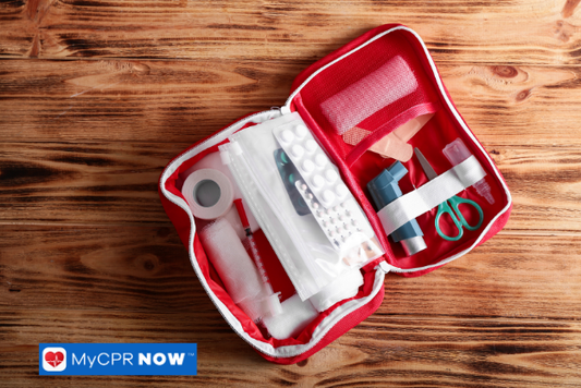 First aid kit on wooden table