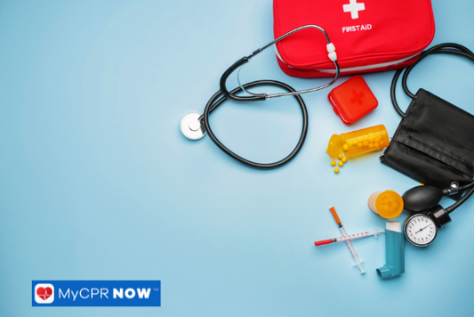 A red first aid kit with a stethoscope, blood pressure monitor, pill bottles, and syringes on a blue background.