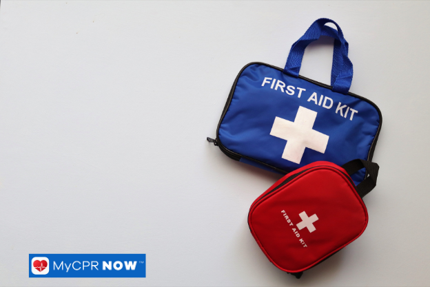 A blue and a red first aid kit placed on a light surface.