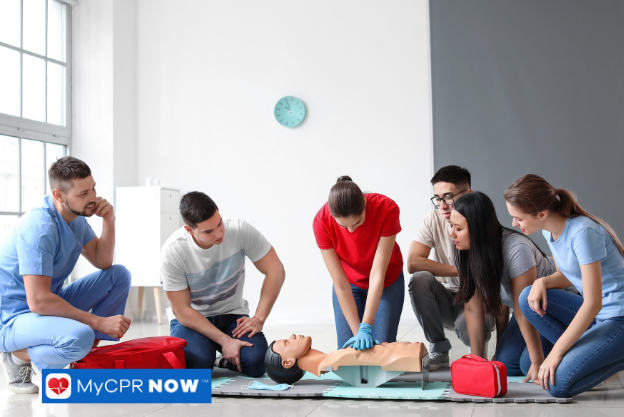 Group doing CPR training on a dummy.