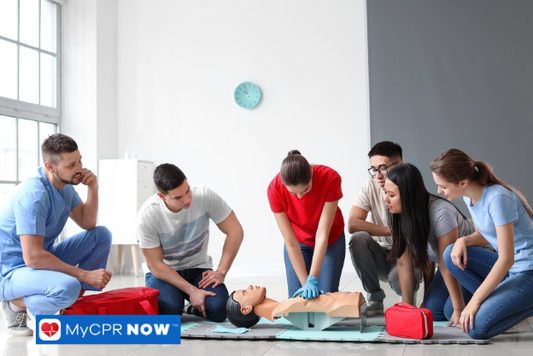 Group doing CPR training on a dummy.
