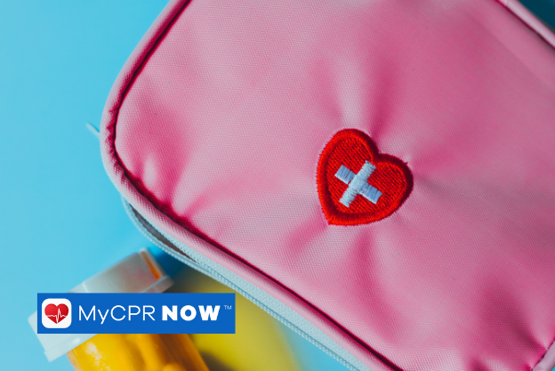 Pink first aid kit with a bottle of medication on a blue background.