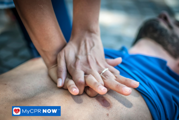 Hands pressing on the chest of a man during CPR.