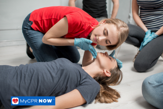 Woman checking breathing by tilting the head of another person.
