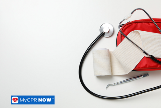 Red first aid kit with medical tools including a stethoscope, bandage, and tweezers on a white background