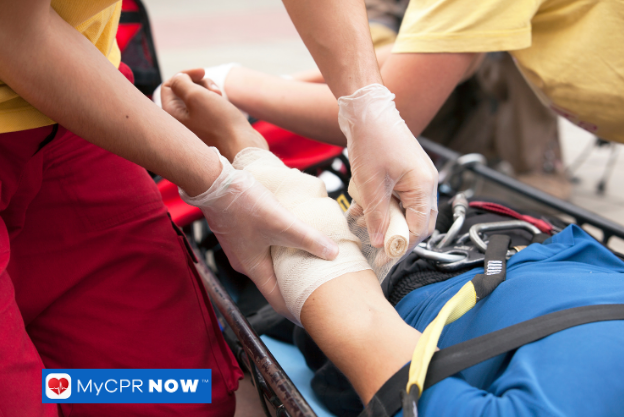 Rescuers bandaging an injured arm.