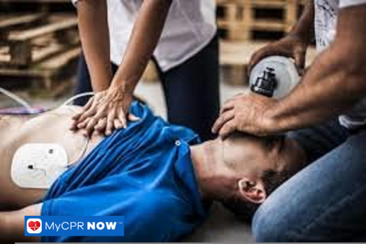 CPR being performed on a man with chest compressions and bag-valve mask ventilation.