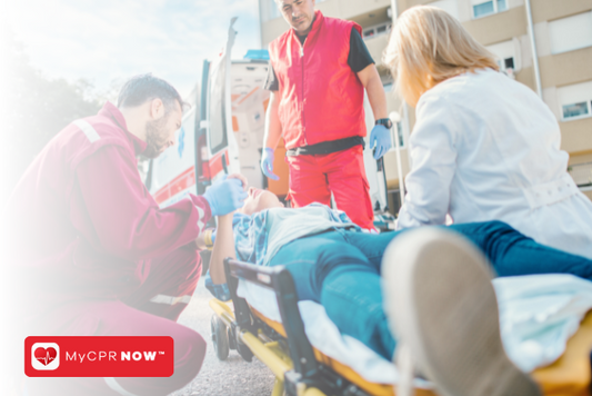 A person laying on a stretcher with three people around them. 