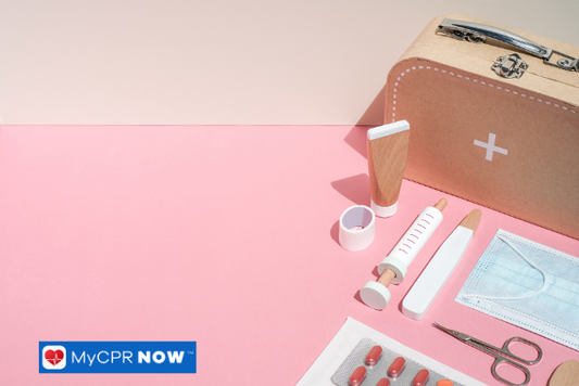 First aid supplies arranged on a pink background.