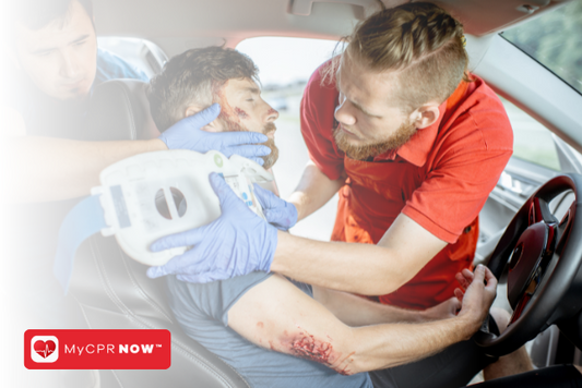 Two people who are helping someone in their car after an accident. 