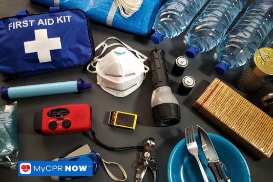 A blue first aid kit with emergency supplies arranged around it.