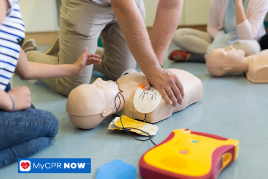 CPR training with AED and mannequin