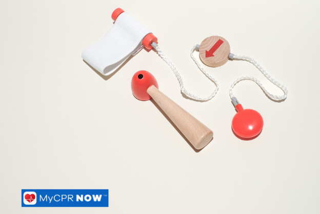 Wooden first aid toy tools – Wooden toy medical tools including a bandage roller and reflex hammer.