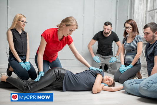 Recovery position training – A first aid instructor demonstrates placing a person in the recovery position during training.