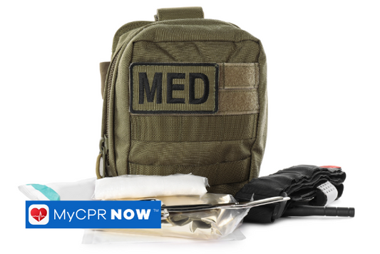 A military medic kit with scissors, gauze, and a tourniquet