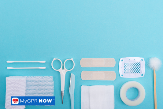 Assorted medical supplies neatly arranged on a blue background.