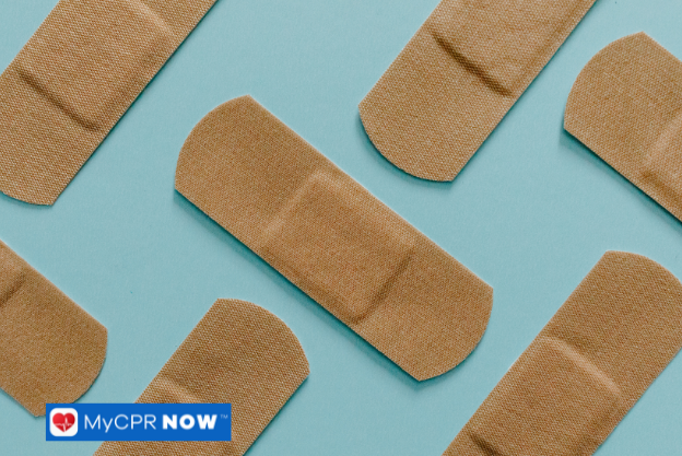 Multiple adhesive bandages arranged in a pattern on a blue background.