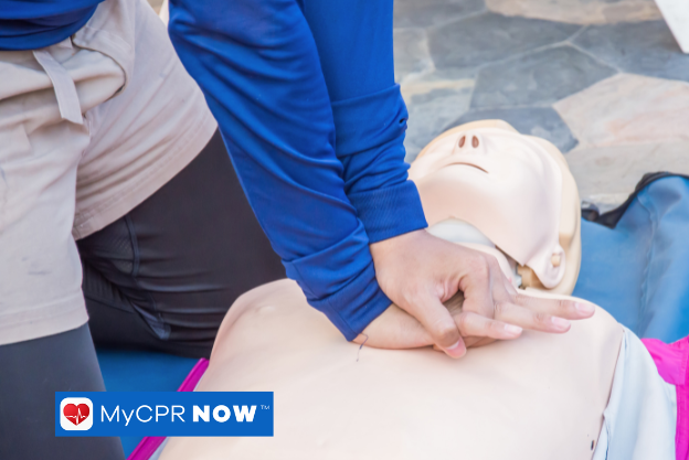 Individual practicing chest compressions during a CPR course.