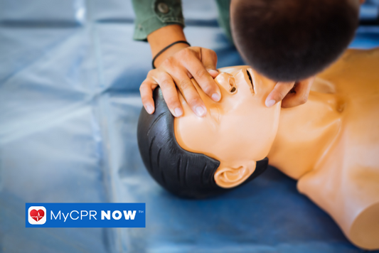 A man is opening the airway to start CPR on the injured training dummy