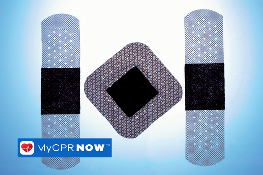 Three blue and black adhesive bandages on a white and blluje background. 