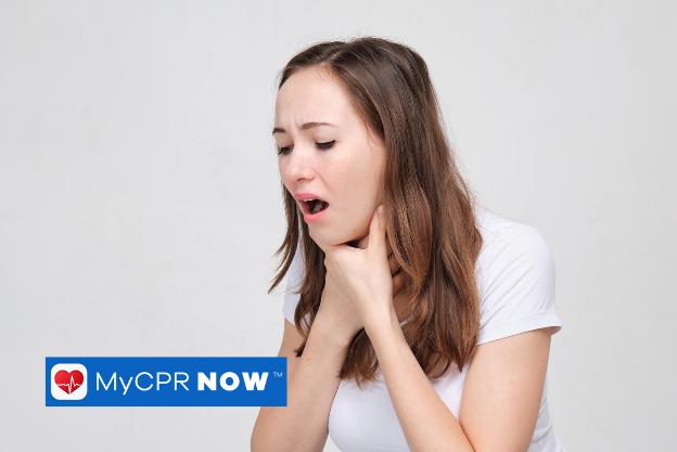 A woman with her hands to her throat choking. 