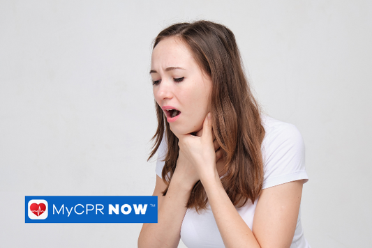 A woman with her hands to her throat choking. 