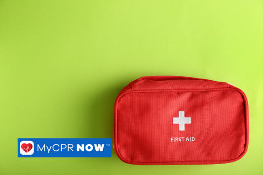 A red first aid kit on a green background. 