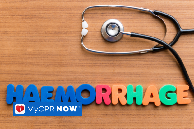 Colorful letters that spell out HEMORRHAGE with a stethoscope above it on a wooden surface. 
