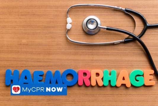 Colorful letters that spell out HEMORRHAGE with a stethoscope above it on a wooden surface. 