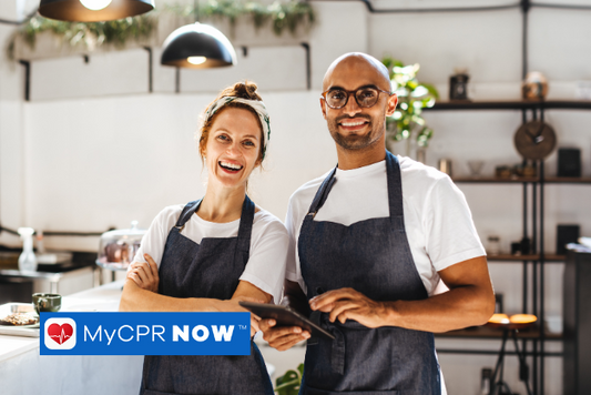 A picture of a woman and a man chef in a kitchen. 