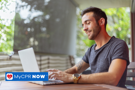 A man working on a laptop with sitting at a table