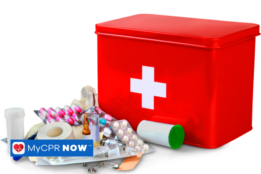 A large red box with a white cross with an assortment of first aid supplies. Bandages, medical tape, safety pins, and pain relievers.