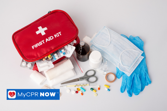 A first aid kit with an assortment of items such as gloves, sissors, medical tape, masks, and bandages.