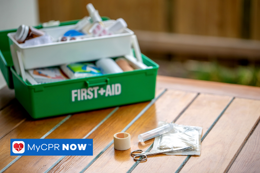 A first aid tackle box filled to the brim with supplies. Cold compress, bandages, waterproof tape, gauze, burn ointment, tweezers, scissors, and latex gloves