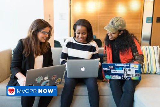 3 women sitting on a couch working on their laptops together