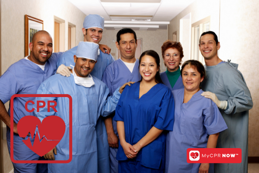 A group of 8 healthcare professonals in a hallway. 