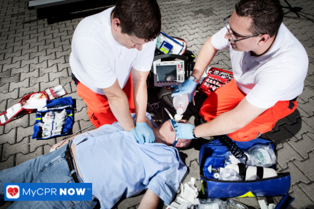 Two first responders are helping a victim with CPR and First Aid.